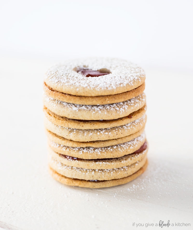 Linzer cookies stacked on top of each other. Almond cookies with jam sandwiched in the center