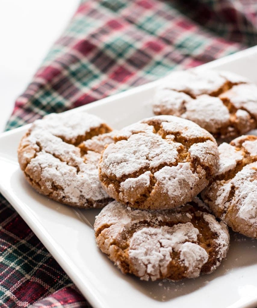 peanut butter crinkle cookies on white plate with plaid fabric