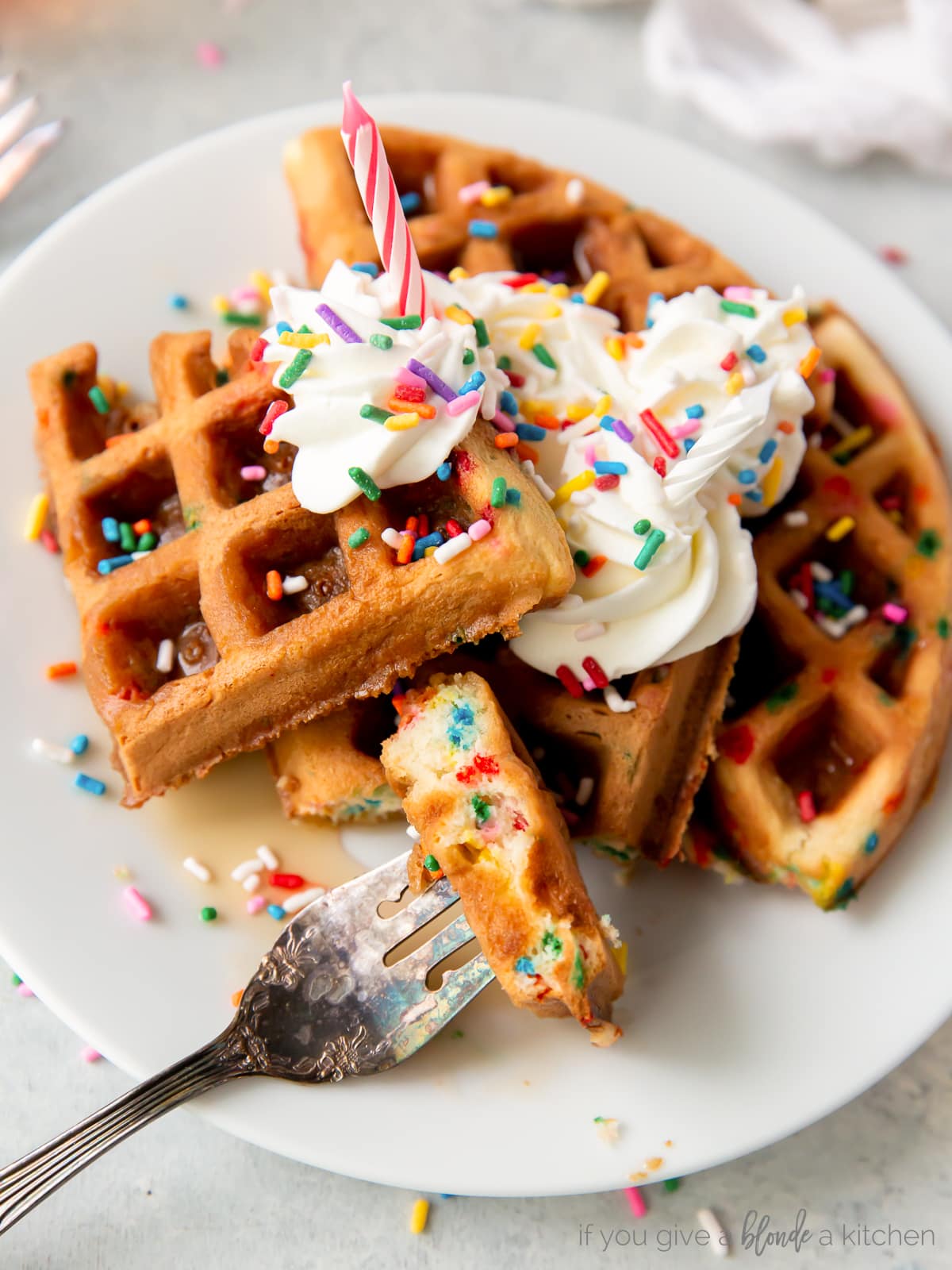 fork with bite of rainbow sprinkle waffles