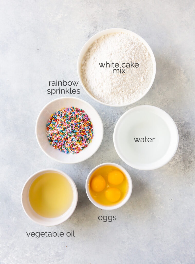 birthday cake mix waffle ingredients in bowls labeled with text