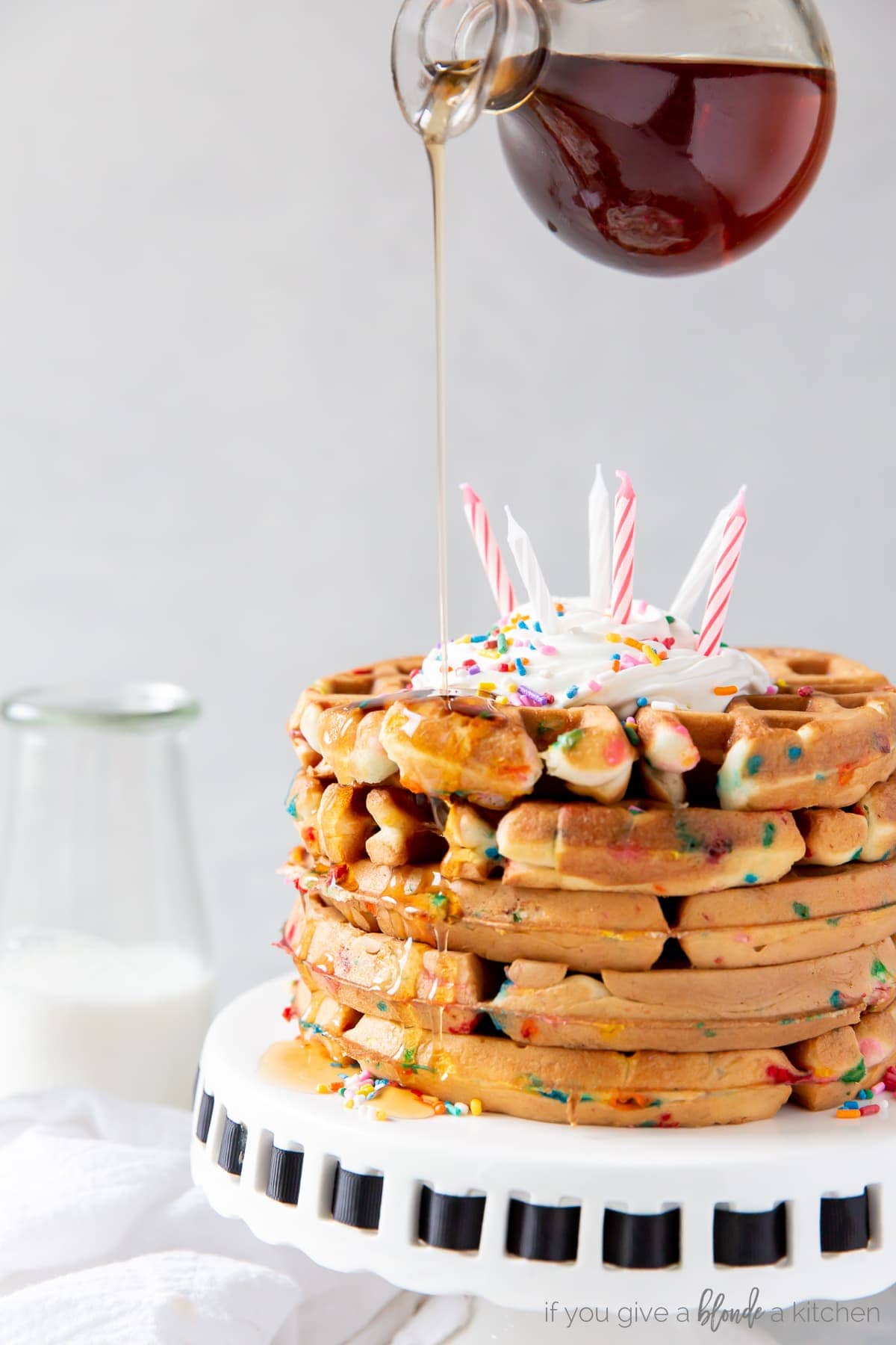 maple syrup poured on stack of funfetti cake mix waffles