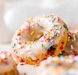 funfetti birthday donut propped up with icing and rainbow sprinkles