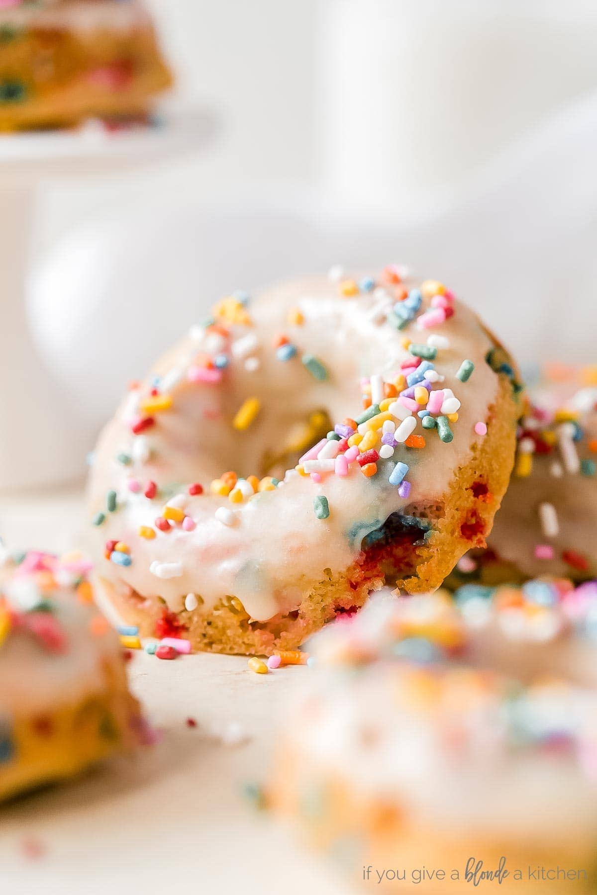 funfetti birthday donut propped up with icing and rainbow sprinkles