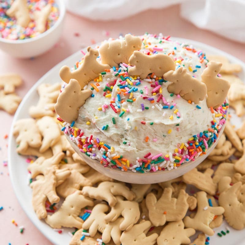 bowl of funfetti cake with with rainbow sprinkles and animal crackers