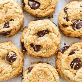 homemade chocolate chip cookies with chocolate chunks and sea salt on parchment paper