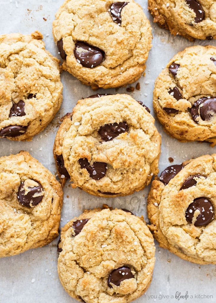 homemade chocolate chip cookies with chocolate chunks and sea salt on parchment paper 