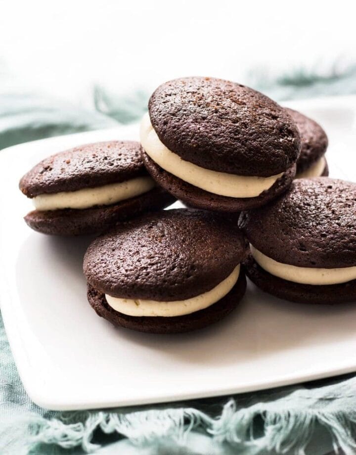 baileys chocolate whoopie pies on white square plate on teal kitchen cloth
