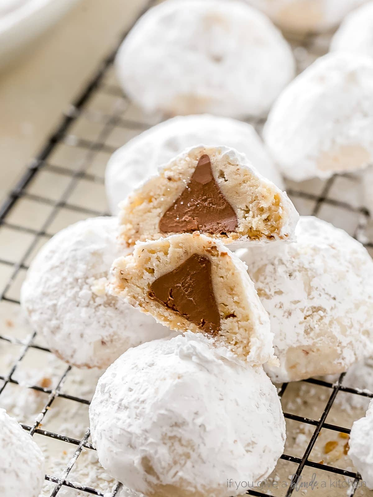 cookie cut in half to show chocolate kiss inside. halves stacked on top of each other