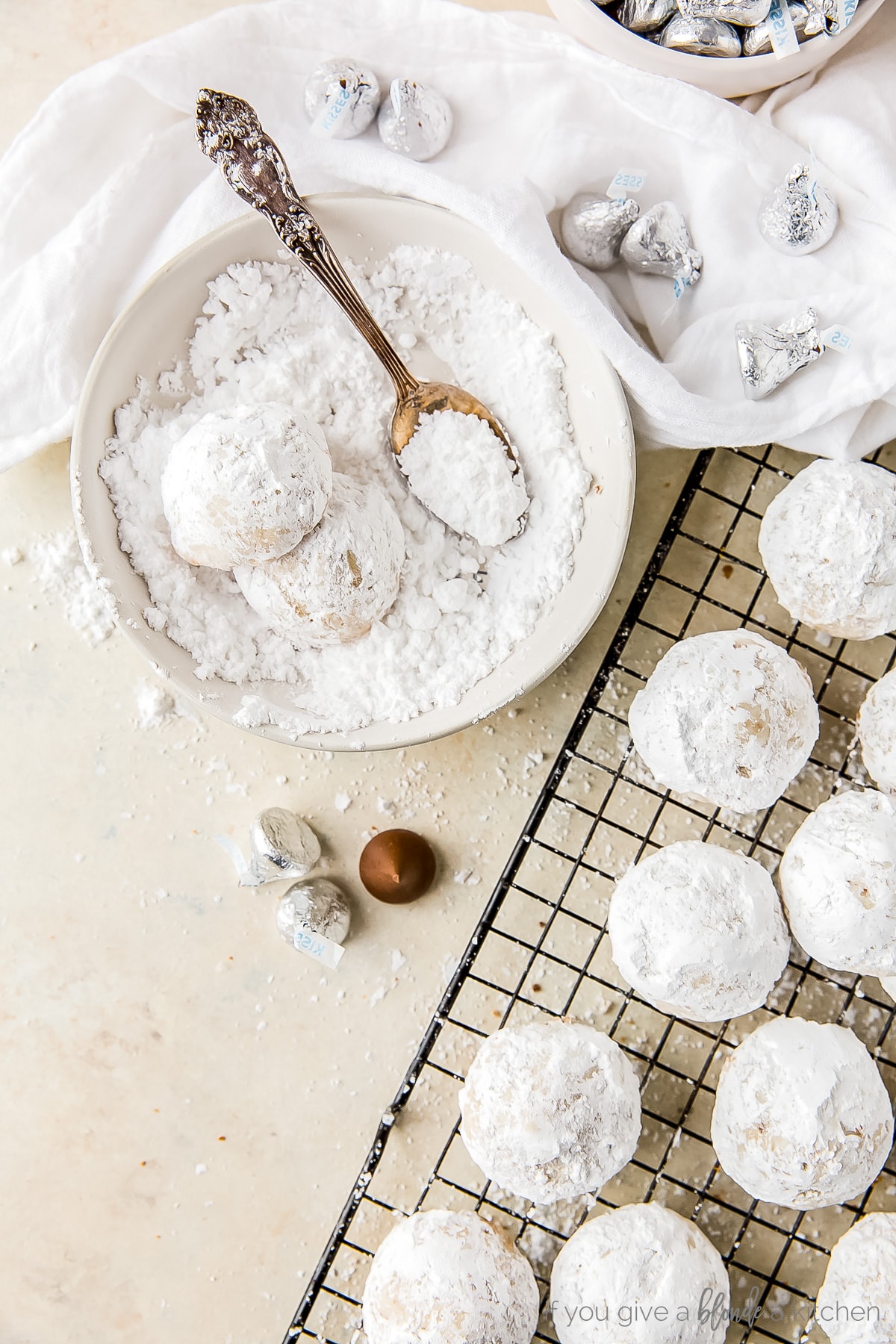 wire cooling rack with white cookies on top covered in confectioners' sugar