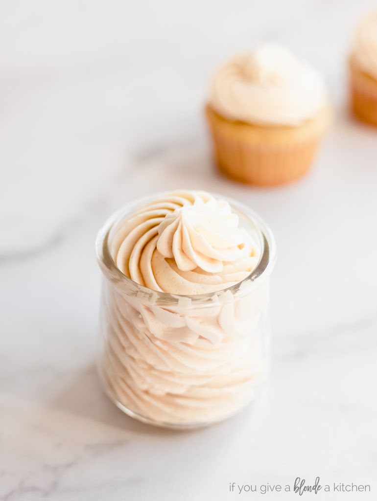 glass jar filled with piped buttercream frosting