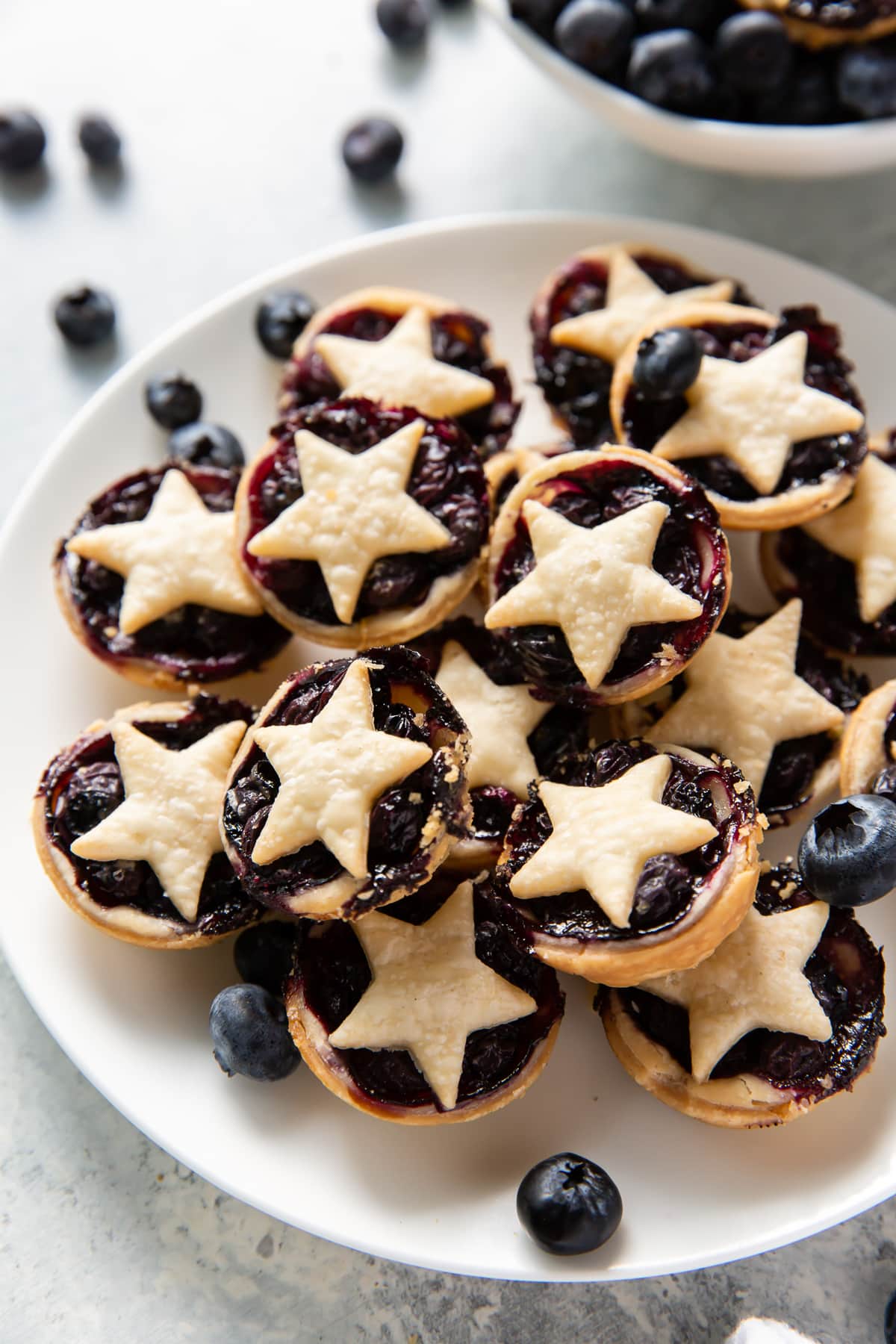 plate with mini blueberry pies with star-shaped top crust