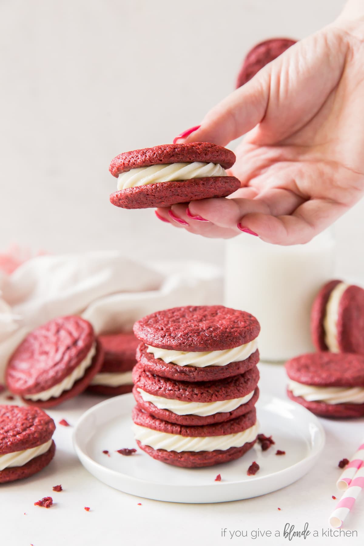 Red velvet sandwich cookies have cream cheese frosting in the center. It's like red velvet cake in cookie form! | www.ifyougiveabloneakitchen.com