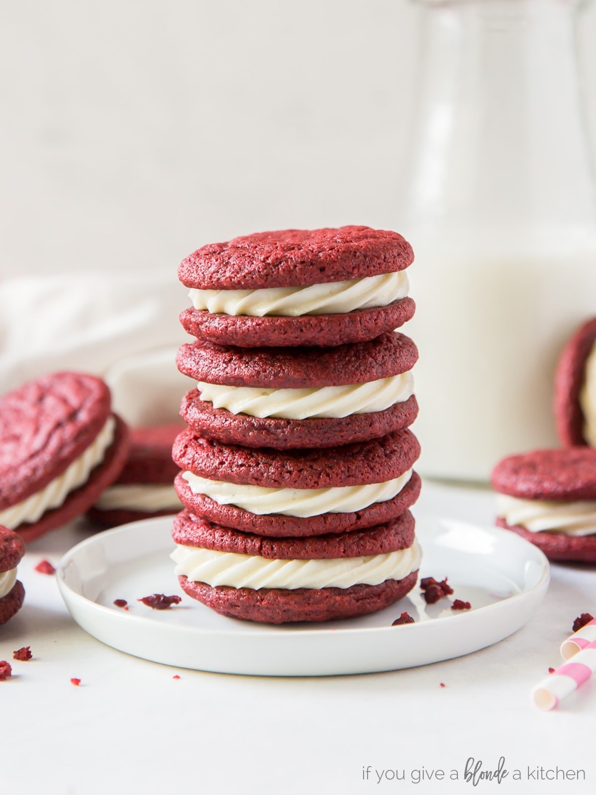 Serve red velvet sandwich cookies at a Christmas party or for Valentine's Day! They're chewy, sweet and have the same flavor as the cake! | www.ifyougiveablondeakitchen.com