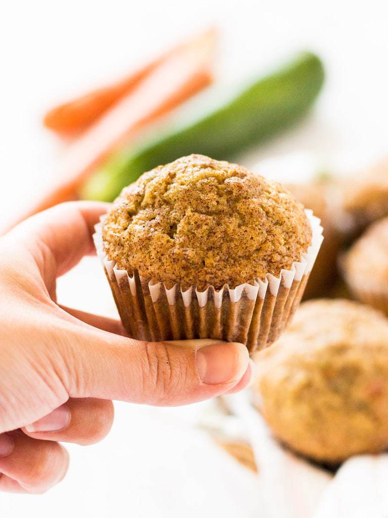 hand holding carrot zucchini muffin