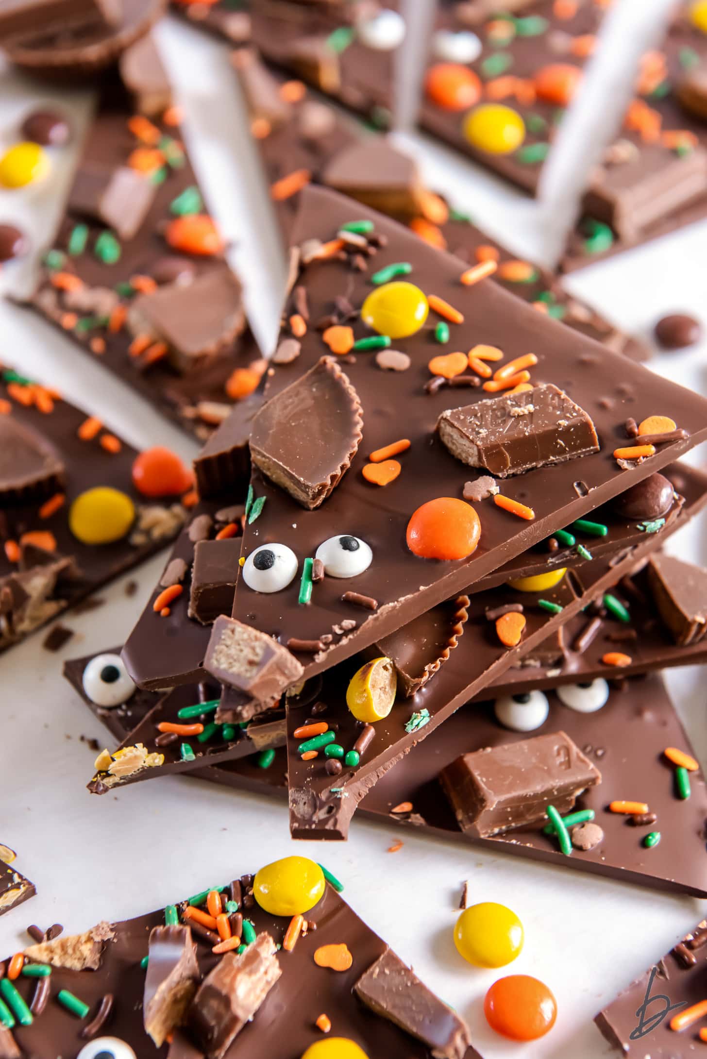 stack of chocolate halloween candy bark with candy pieces and sprinkles
