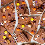 Halloween candy bark is chocolate bark covered in candy and broken into pieces for a sweet and spooky treat! | www.ifyougiveablondeakitchen.com