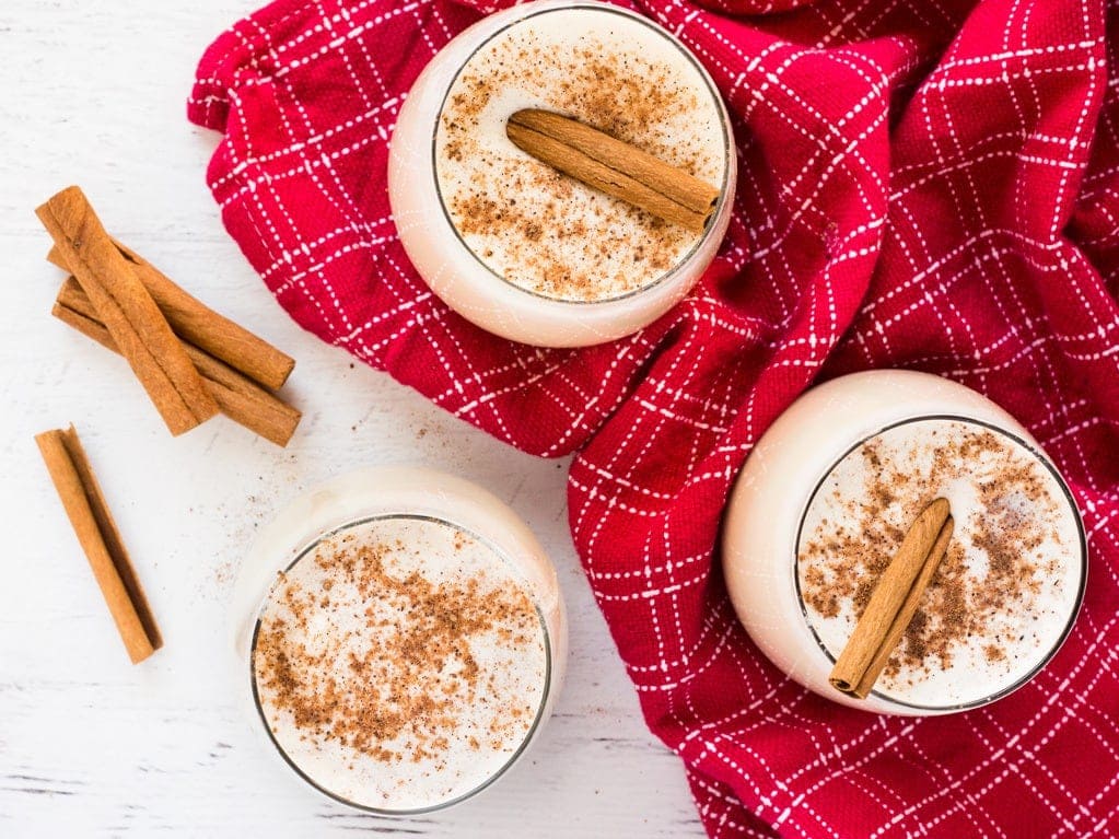 This easy homemade eggnog is topped with nutmeg and a cinnamon stick for a festive touch. The holiday drink is easy to make in your Vitamix blender! | www.ifyougiveablondeakitchen.com