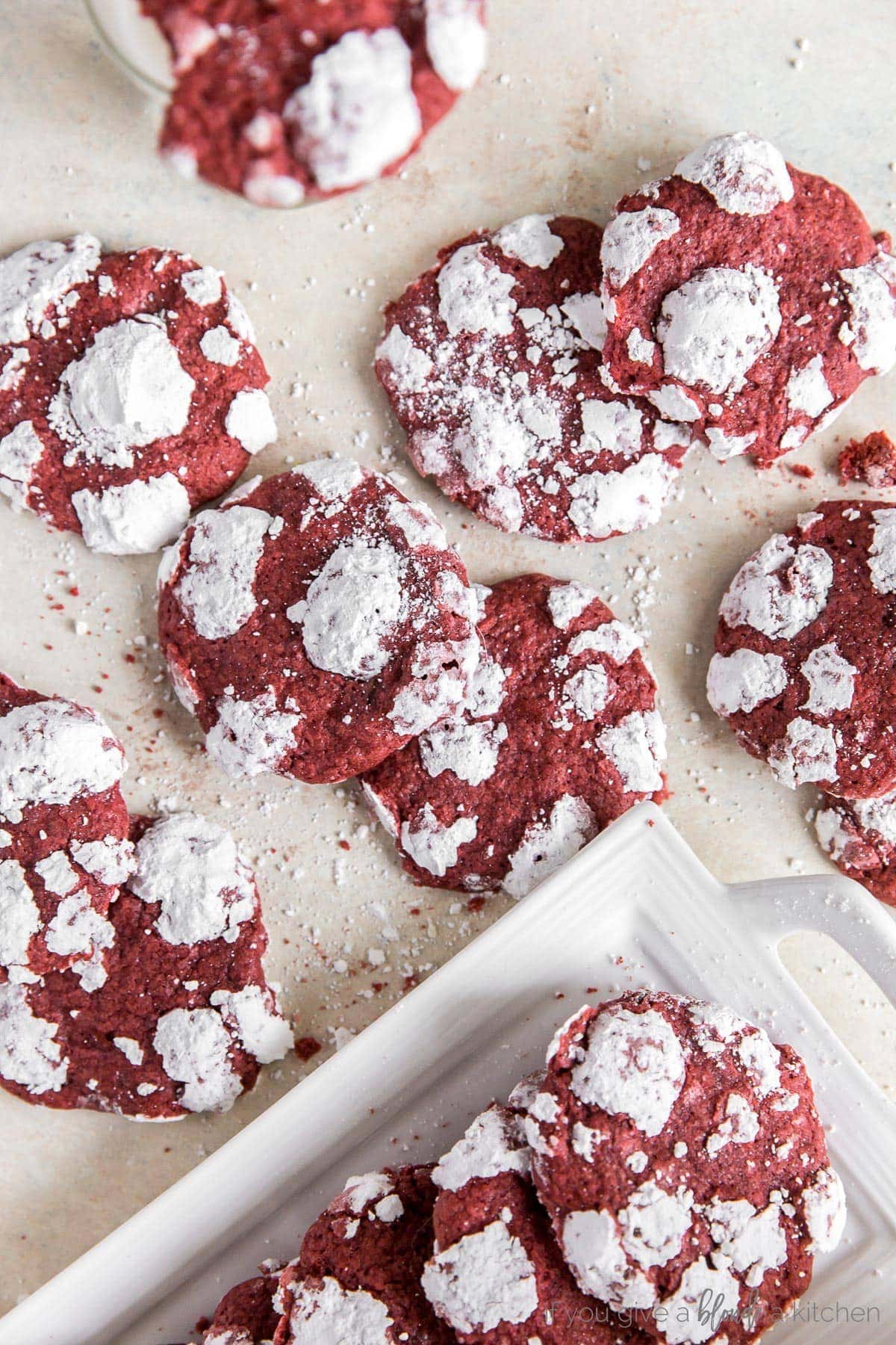 red velvet crinkle cookies with powdered sugar scattered on surface.