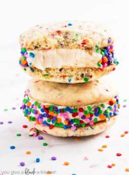 Birthday cake ice cream sandwiches are an easy homemade dessert for summer. Use rainbow sprinkles and homemade sugar cookies to make this sweet treat! | www.ifyougiveablondeakitchen.com