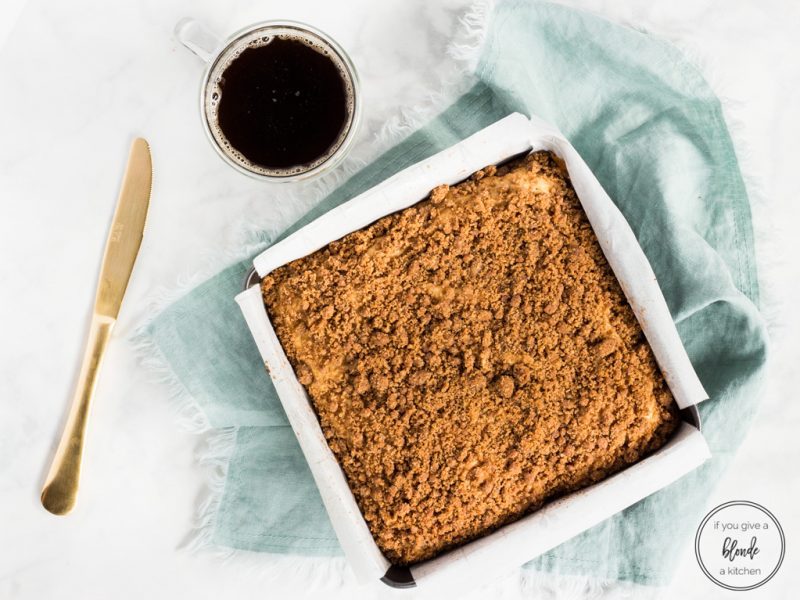 Irish cream coffee cake in pan with coffee and gold knife