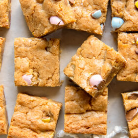 mini egg easter blondies cut into squares on wax paper