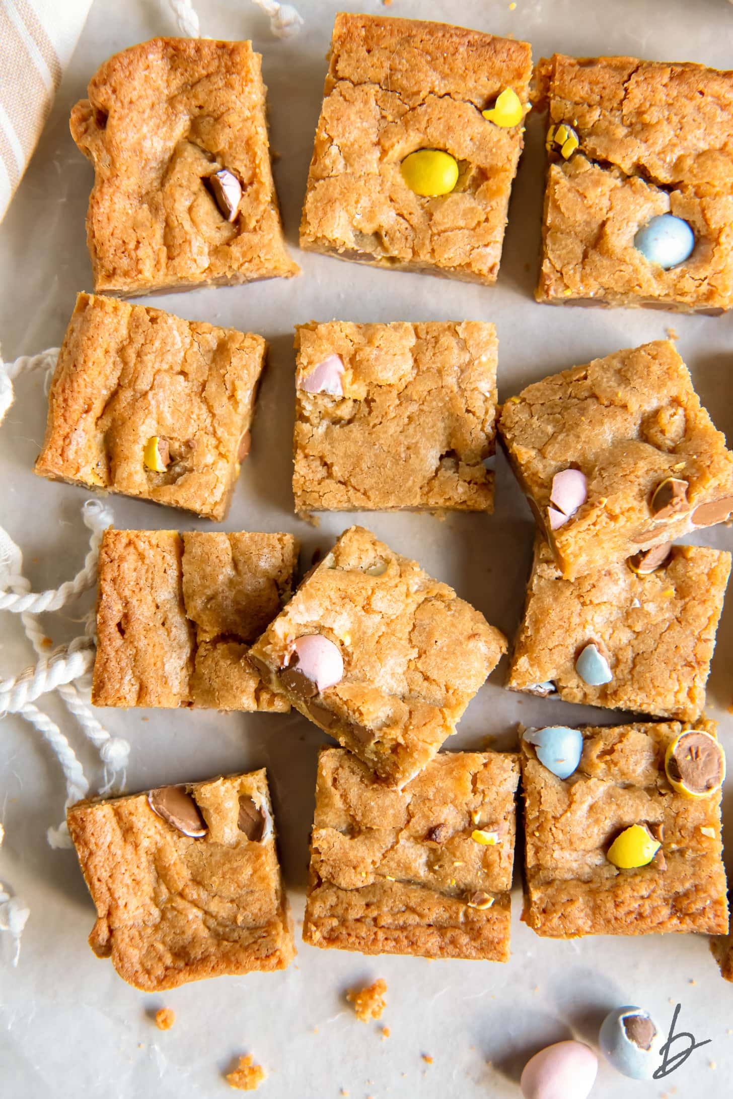 Mini egg Easter blondies cut into squares on wax paper