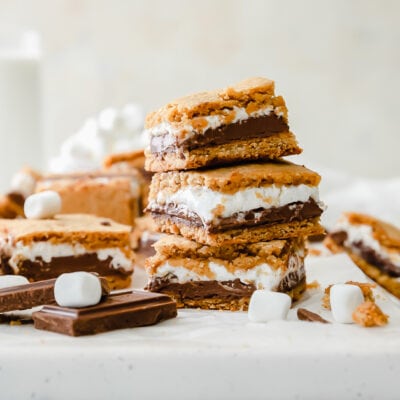 smores bars stacked on top of upside down baking sheet