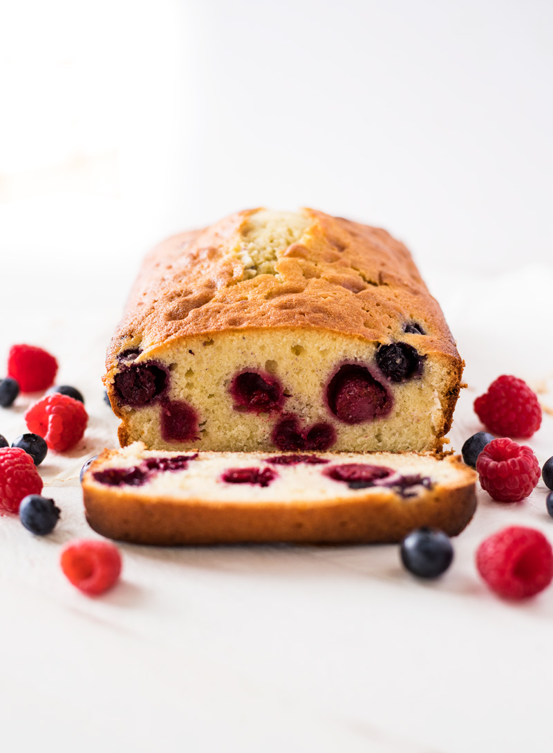 Blueberry raspberry pound cake slice inside of cake with berries