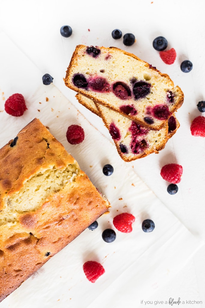 blueberry raspberry pound cake loaf with slice and berries