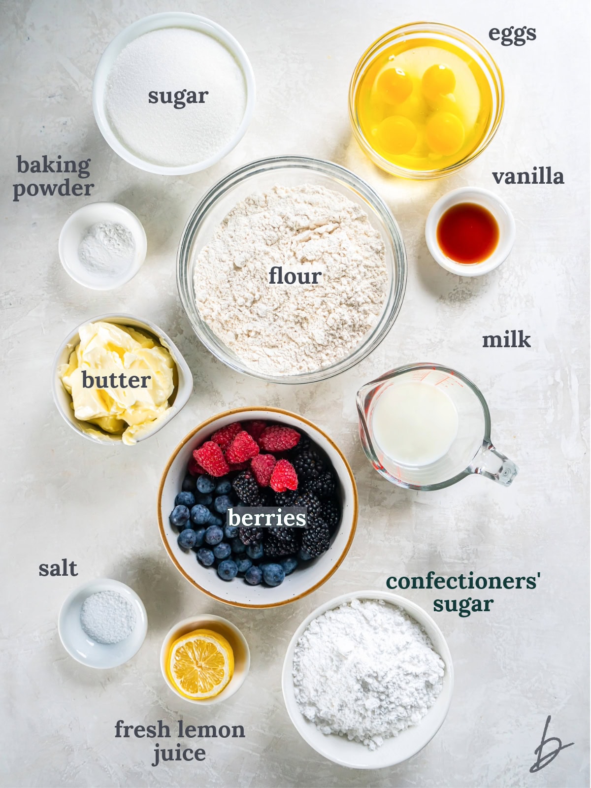 tabletop with bowls of ingredients to make mixed berry pound cake.
