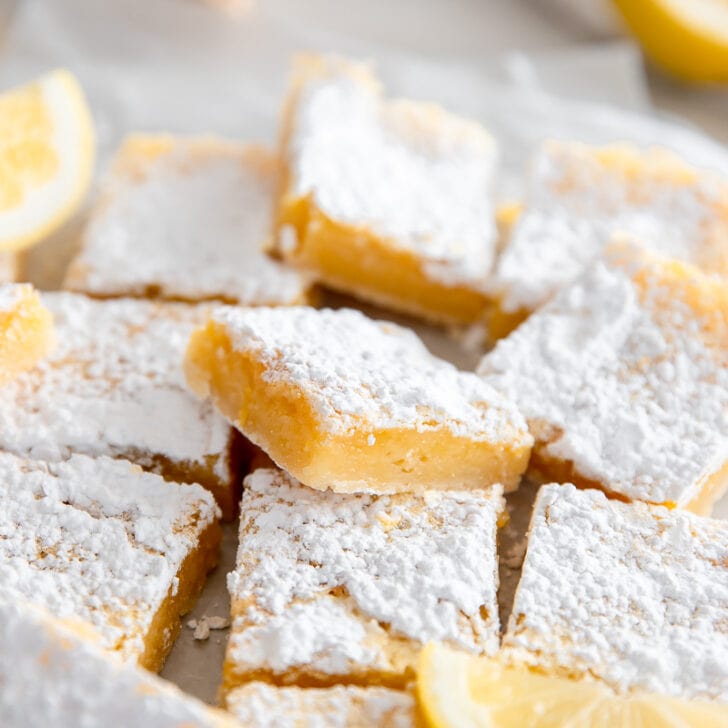 lemon bars in a pile and one propped up showing layers