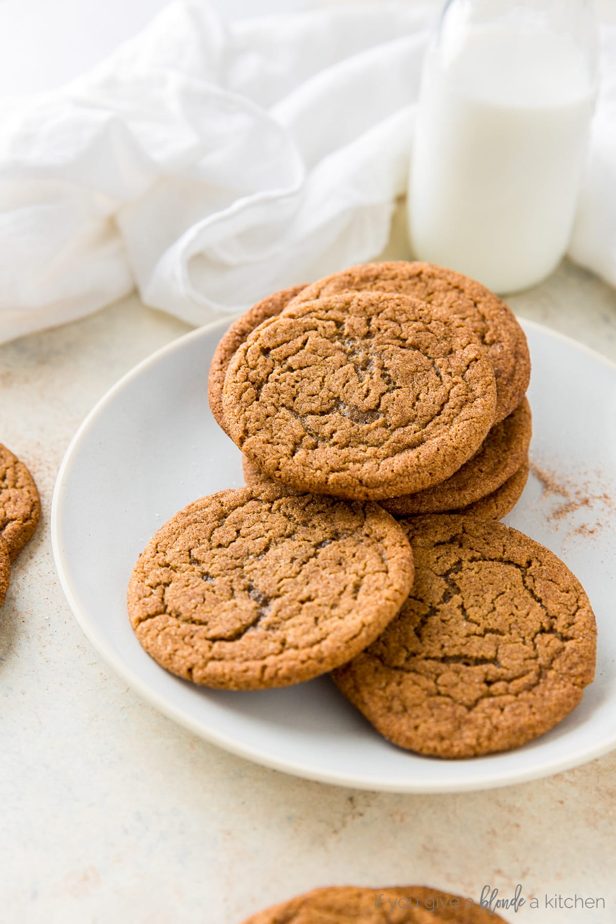 Chewy ginger molasses cookies in a stack with red baking twine