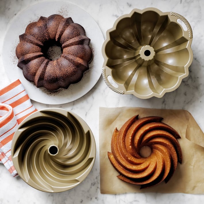 gold bundt cake pans next to bundt cakes