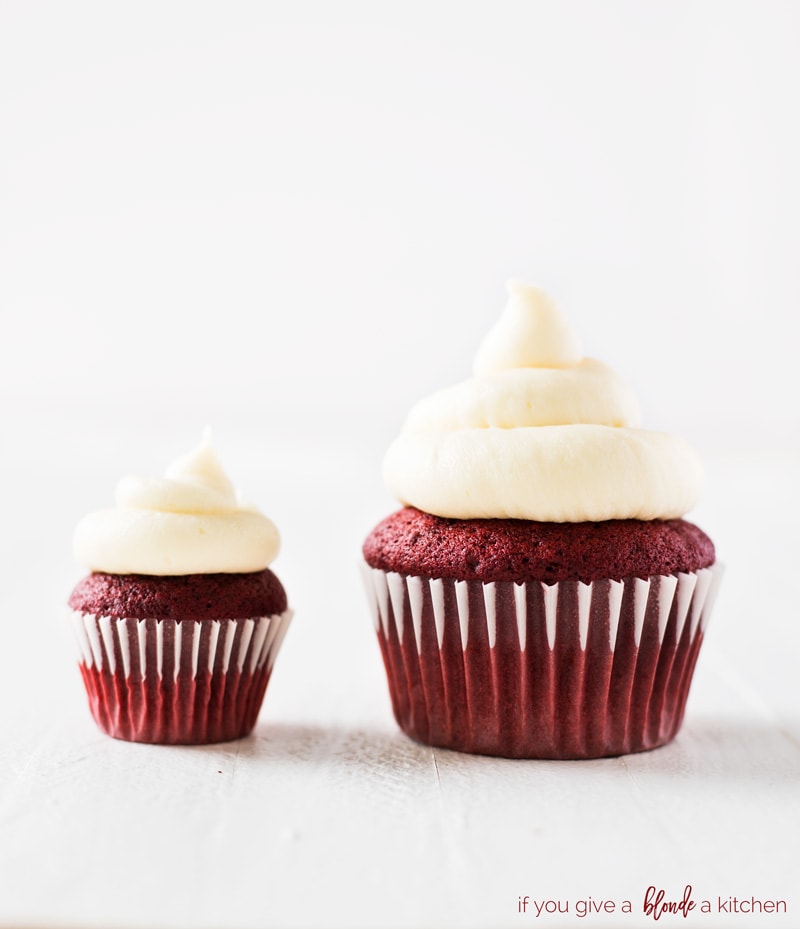 mini red velvet cupcakes and standard size next to each other