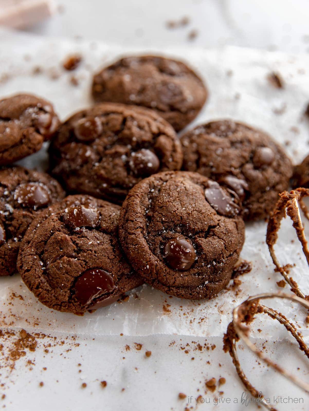 double chocolate chip cookie recipe on parchment paper with dark chocolate chips