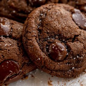 two double chocolate chip cookies with melted chocolate chips and sea salt