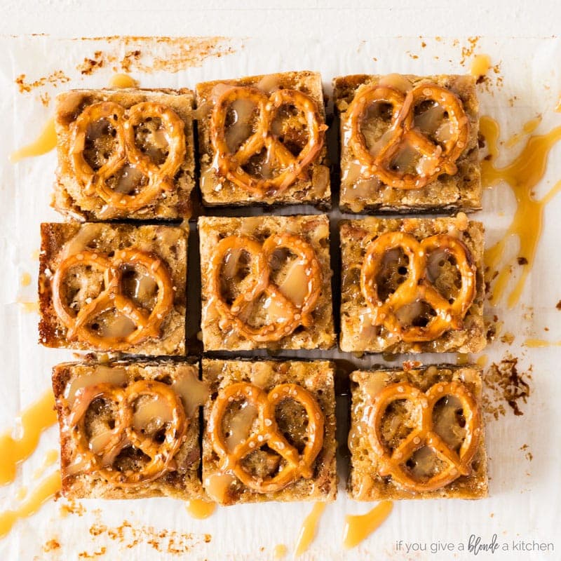 salted caramel pretzel blondies cut into square with pretzels on tops and drizzle of caramel