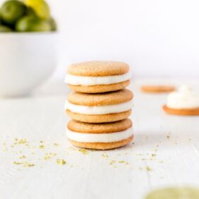 key lime pie cookies stacked on top of each other with lime in a bowl