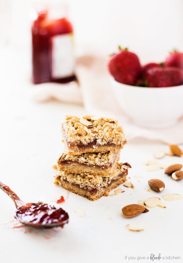 strawberry oat bars stack of three bars with almond and strawberry jam