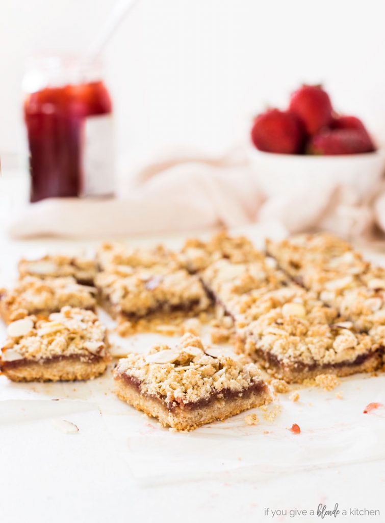 strawberry oat bars are made with almond flour in the crust and crumble. Strawberry jam is spread in the center.