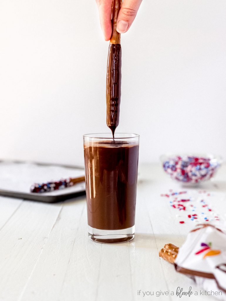 chocolate covered pretzel rods dipped in melted chocolate glass