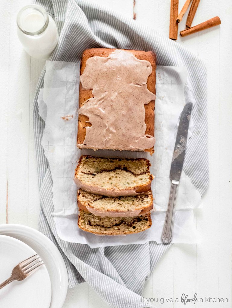 cinnamon swirl cake slices on parchment paper and kitchen cloth