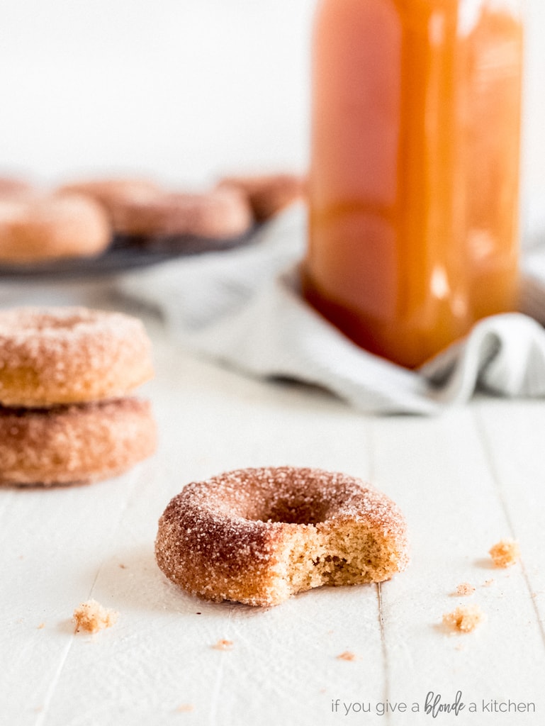 baked apple cider donuts with bite and crumbs