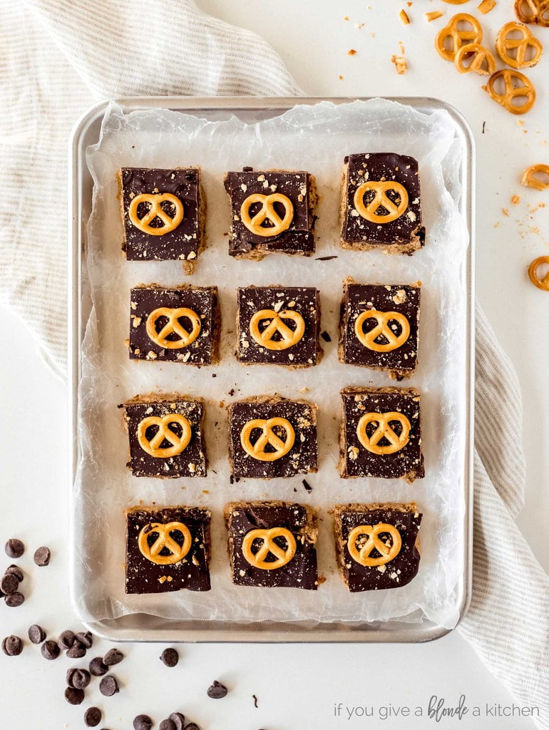 chocolate peanut butter pretzel bars cuts in squares on baking sheet