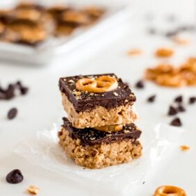 two peanut butter pretzel bars stacked on top of each other