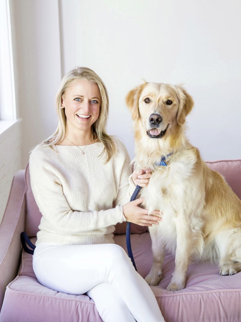 haley blonde and hudson golden retriever sitting on sofa