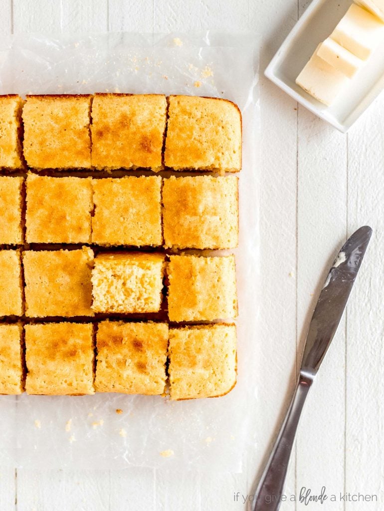 slice of cornbread turned up butter knife and butter dish