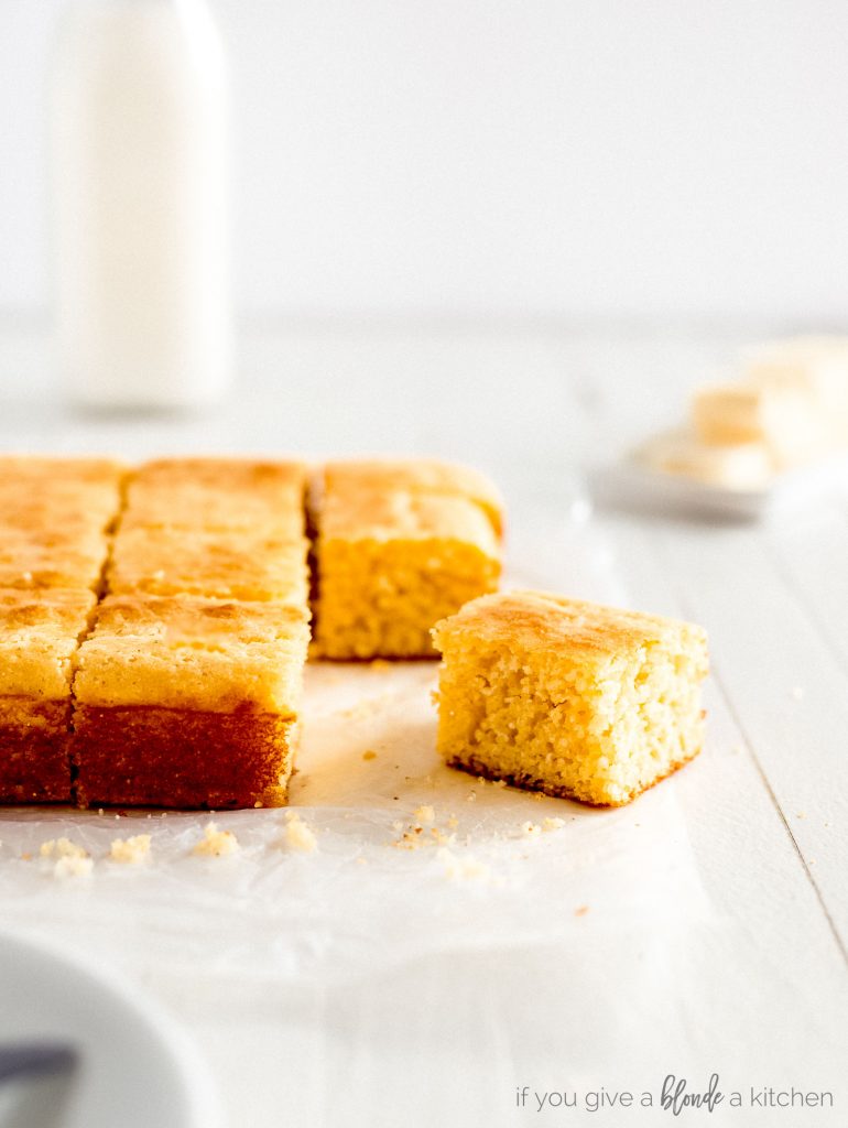 slice of cornbread on parchment paper with crumbs