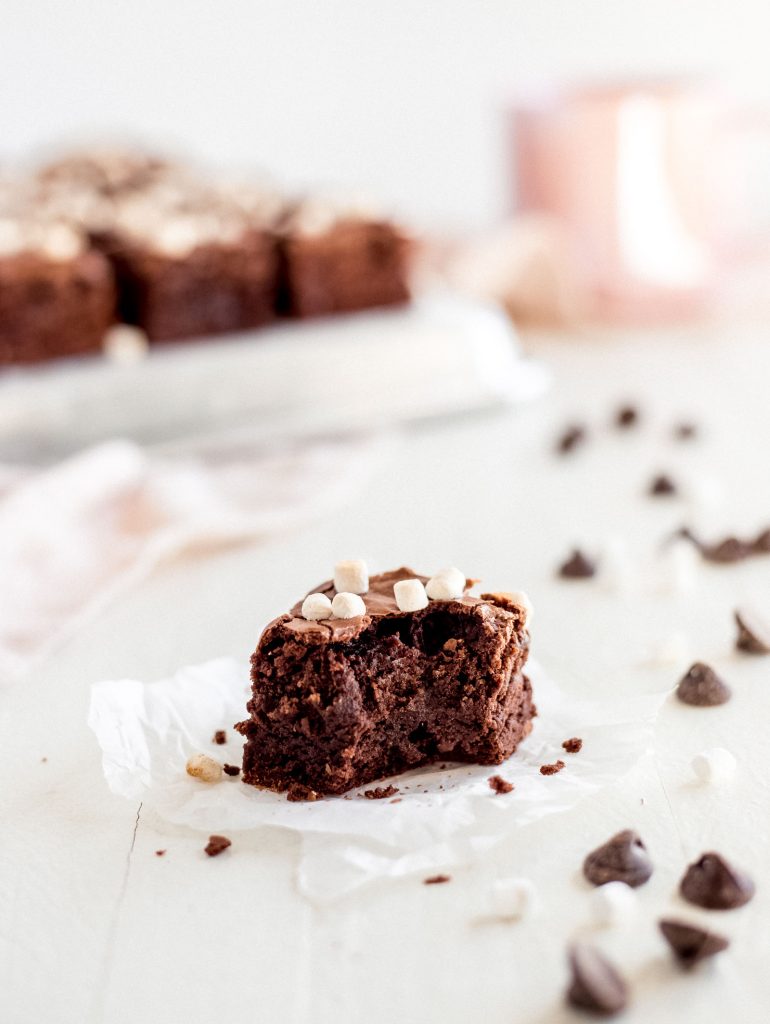 hot chocolate brownie with a bite on parchment paper