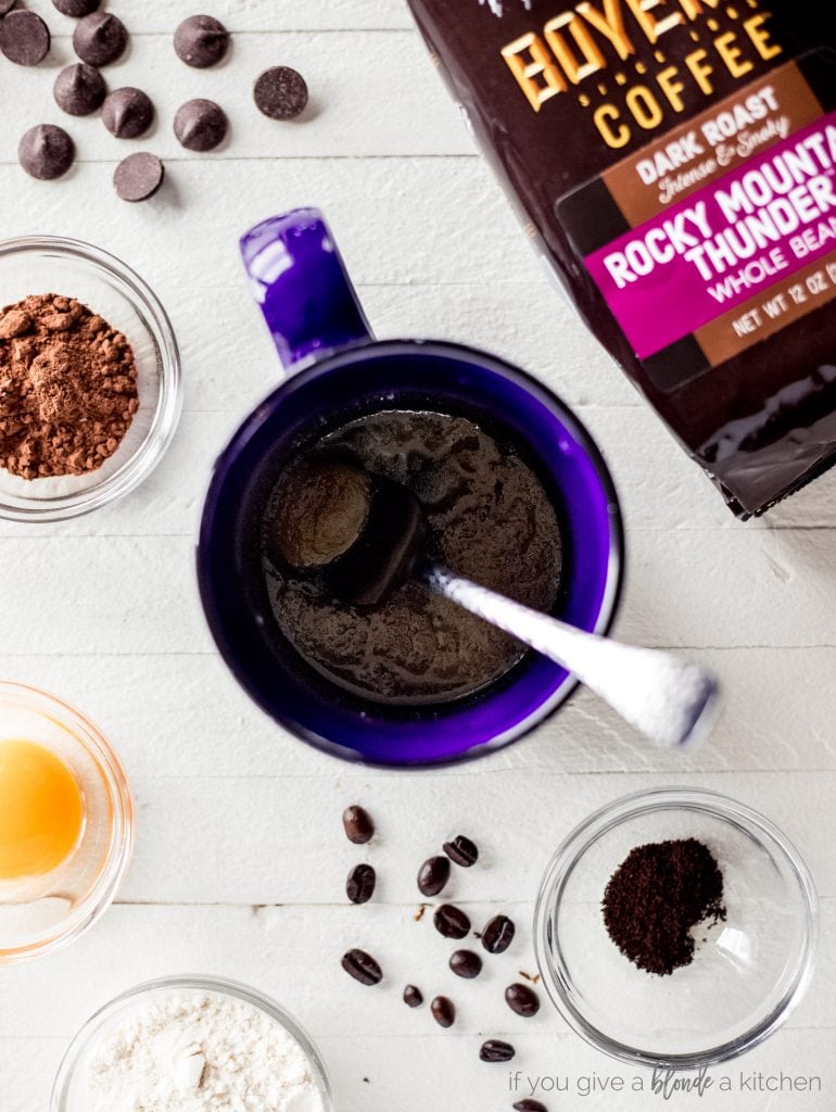 blue mug with spoon and double chocolate chip cookie ingredients